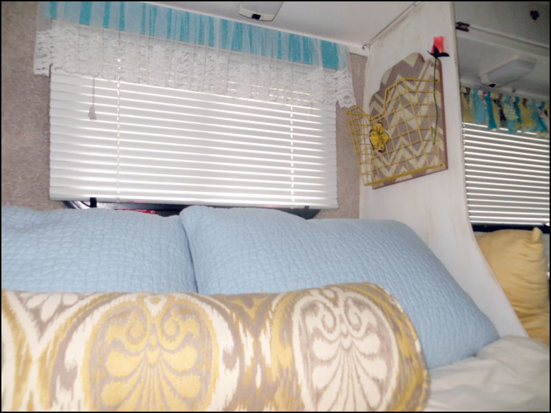 View of Magazine Rack added to Interior wall by bedding of a Casita Travel Trailer.
